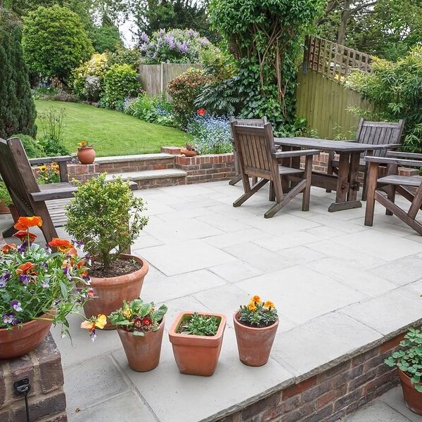 R&J Lawn Care Rock Hill SC - Hardscaping 2 a patio with potted plants and a table